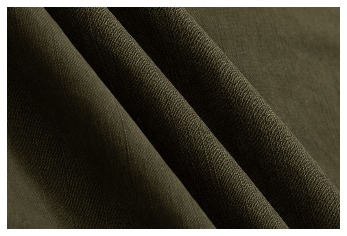 Macro view of the textured olive drab garment fabric and its weave.