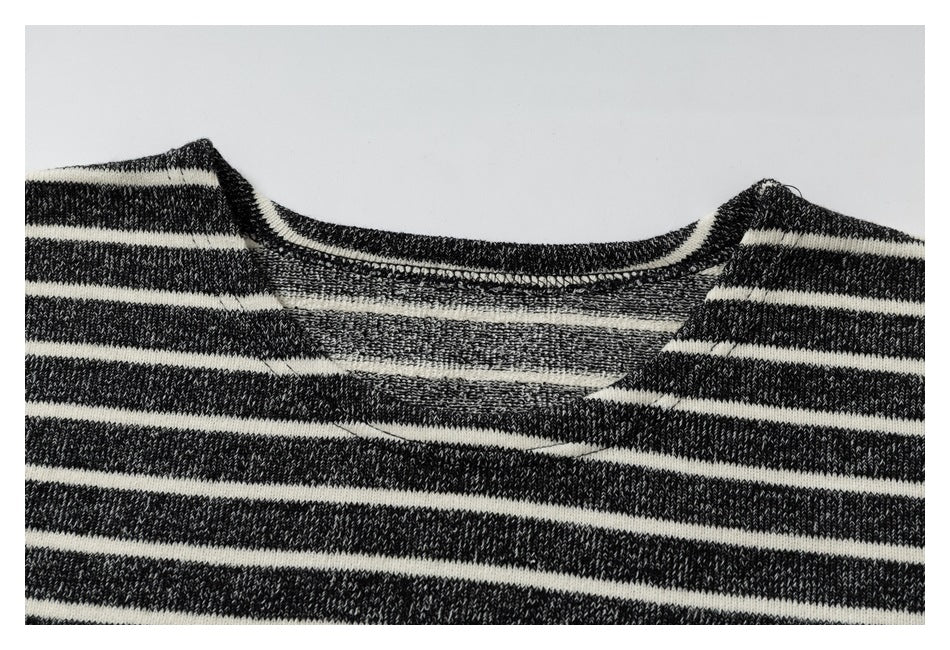 Close-up of the striped top's wide neckline, showing the knit texture and inner seam finishing.