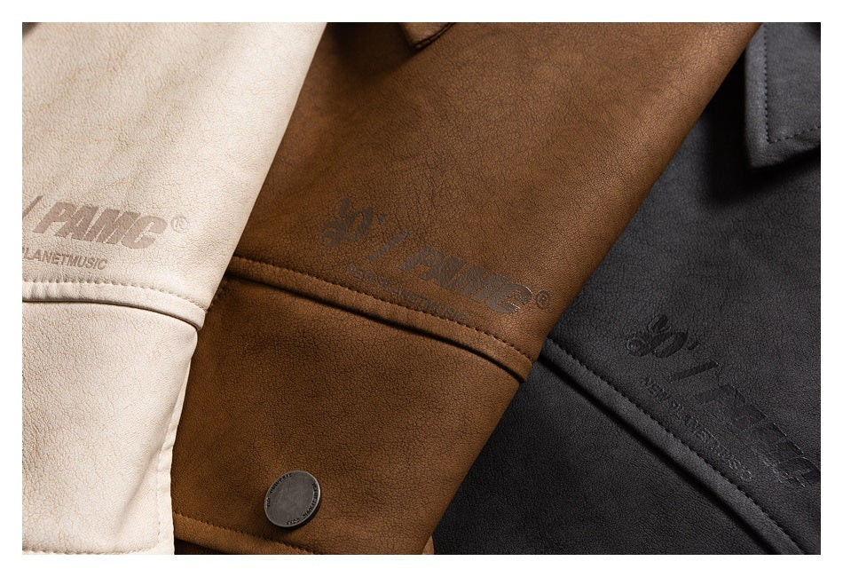 Close-up of cream, brown, and charcoal jacket panels with embossed English branding and a button.