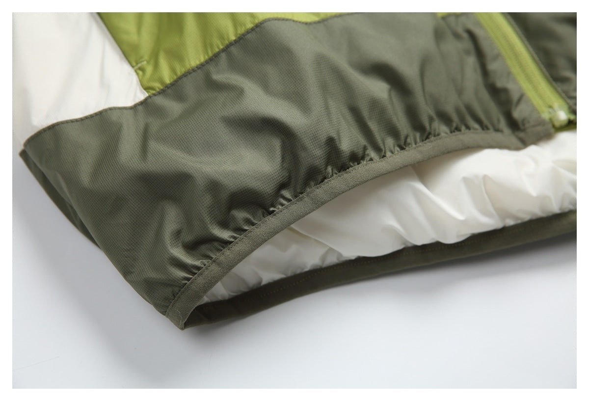 Close-up of an olive-green garment hem with gathered stitching and white and lime-green panels.