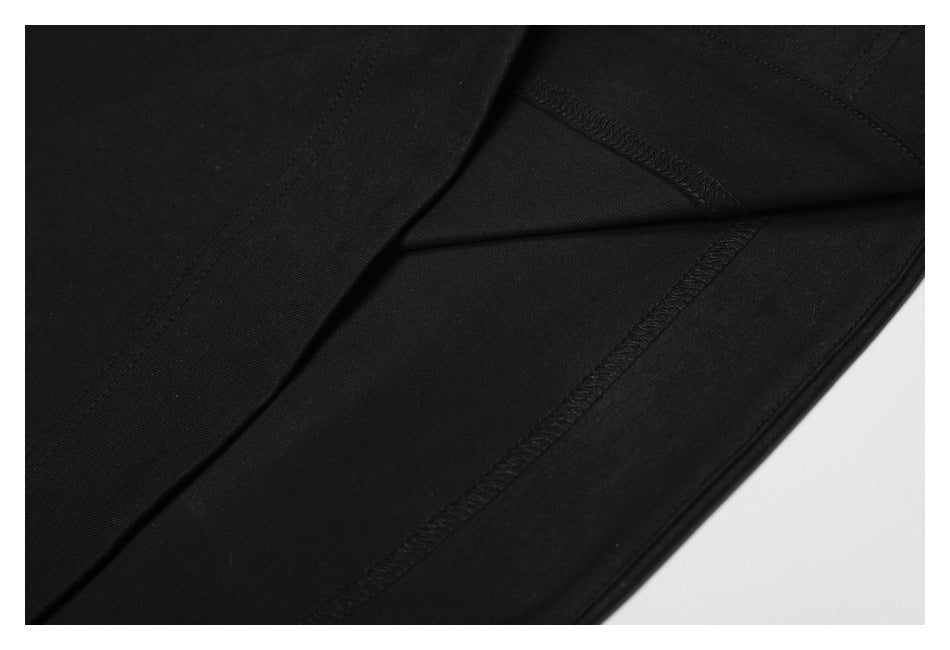Close-up of the black shirt's inside hem and overlocked seam stitching.