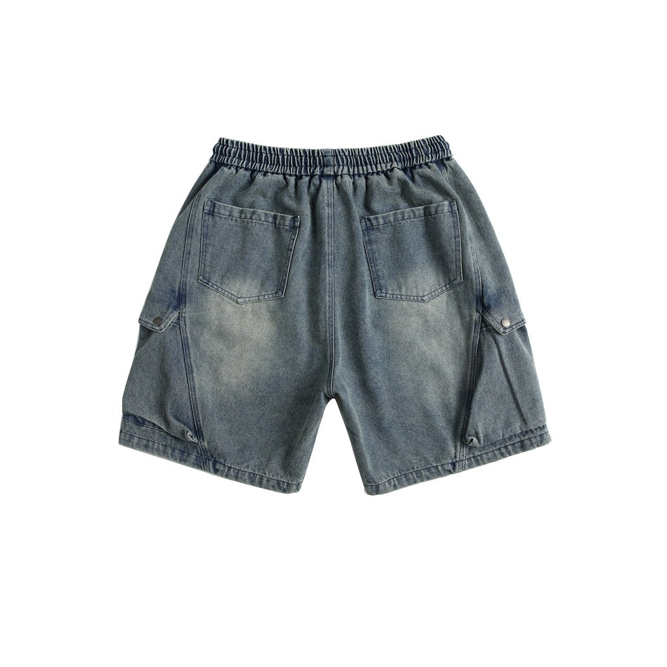 Back view of faded blue denim shorts showing two patch pockets and elastic waistband