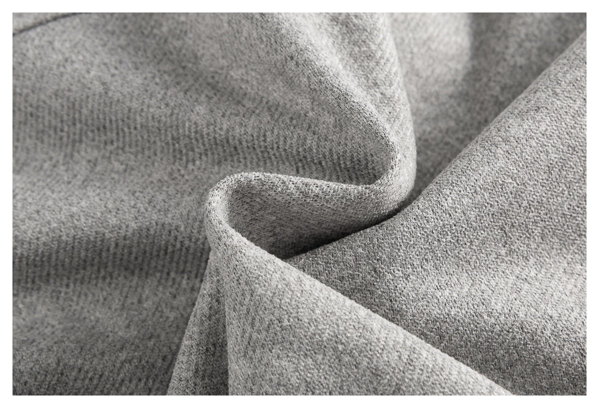 Close-up of gray garment fabric folded to show its surface texture.