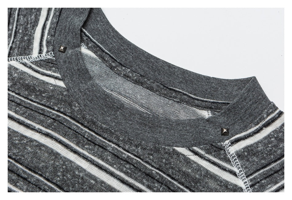 Close-up of a charcoal gray striped shirt neckline with contrasting white stitching and small metal studs.