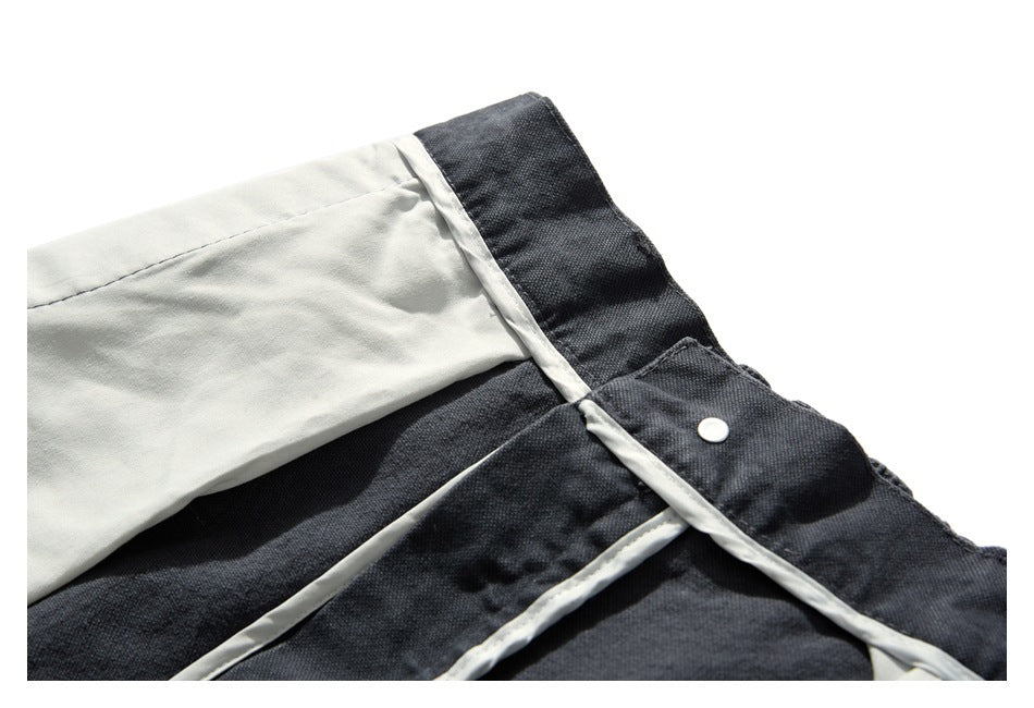 Inside view of charcoal trousers showing pale lining along the waistband and fly.