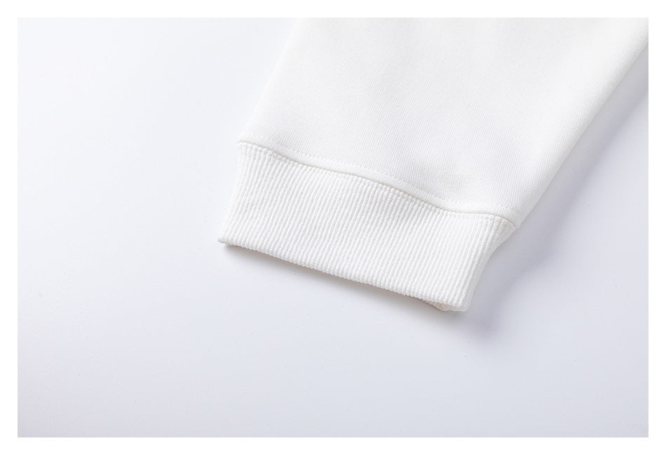 Close-up of a white sweatshirt sleeve ending in a ribbed cuff.
