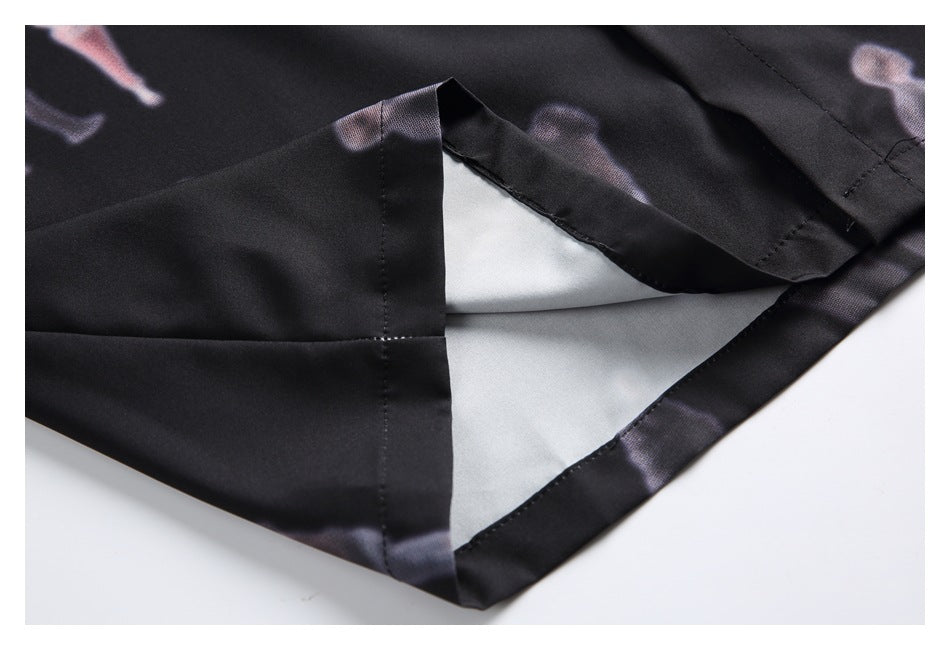Close-up of the black shirt's side hem and slit, showing the inner facing and stitching.