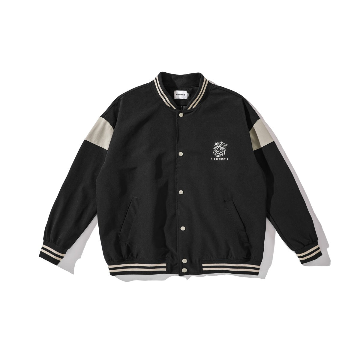 Black baseball jacket with cream-striped ribbed trim, beige shoulder panels, snap front and small tiger graphic on chest