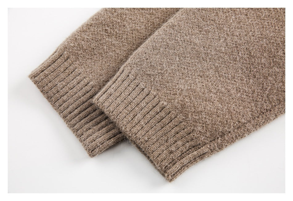 Two ribbed edges of a taupe-brown knit garment overlap against a white background.
