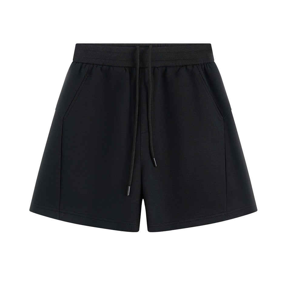 Black wide-leg drawstring shorts with ribbed waistband and slanted side pockets, flat front view