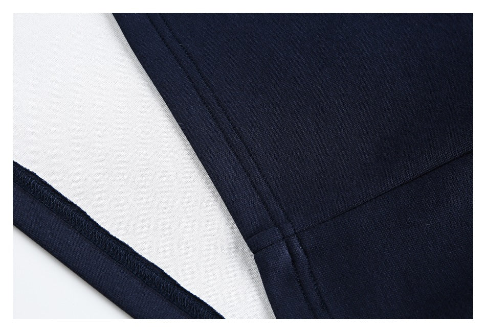 Close-up of a navy garment seam with white inner fabric and visible overlocked stitching.