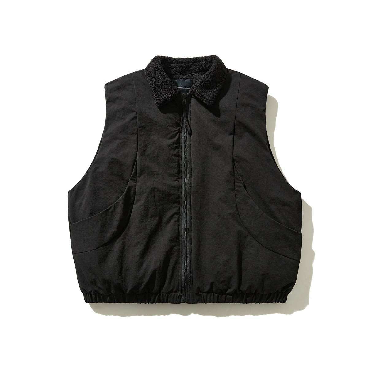 Black sleeveless zip vest with fleece-like collar, curved pockets and elastic hem, flat front view