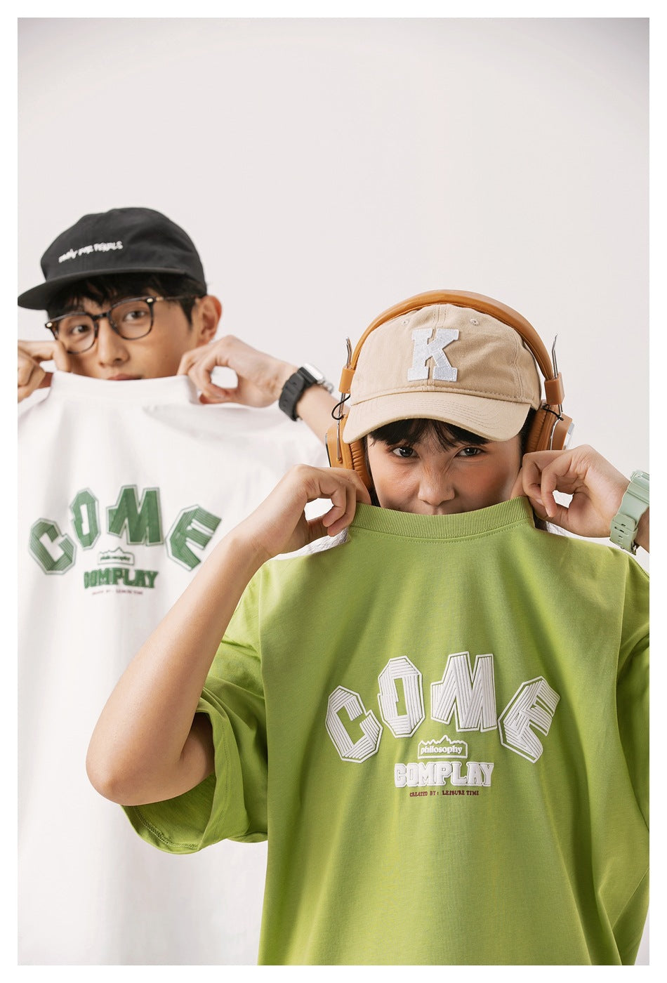 Close view of a model wearing a lime green oversized T-shirt with a large white chest graphic.