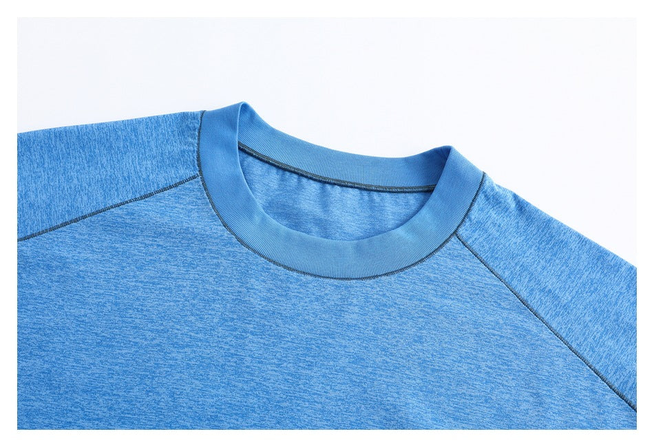 Close-up of a heather blue T-shirt's crew neckline, collar band, and raglan shoulder seams.
