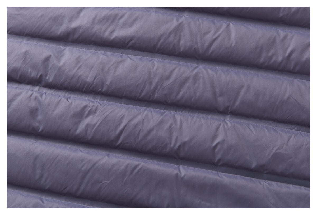 Close-up of muted lavender-gray fabric with wide horizontal padded channels.