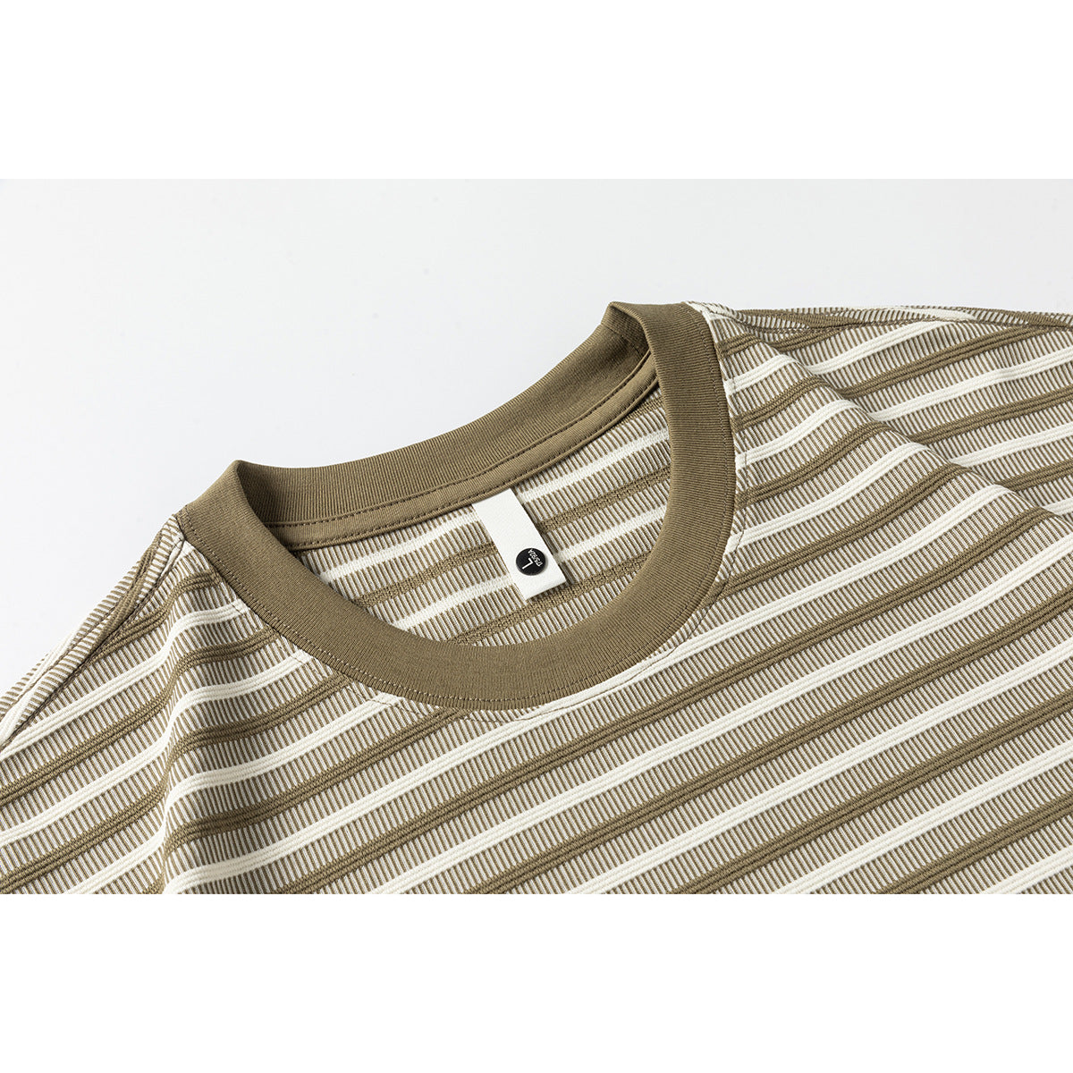 Close-up of a brown ribbed crew neckline on an ivory and brown striped T-shirt.