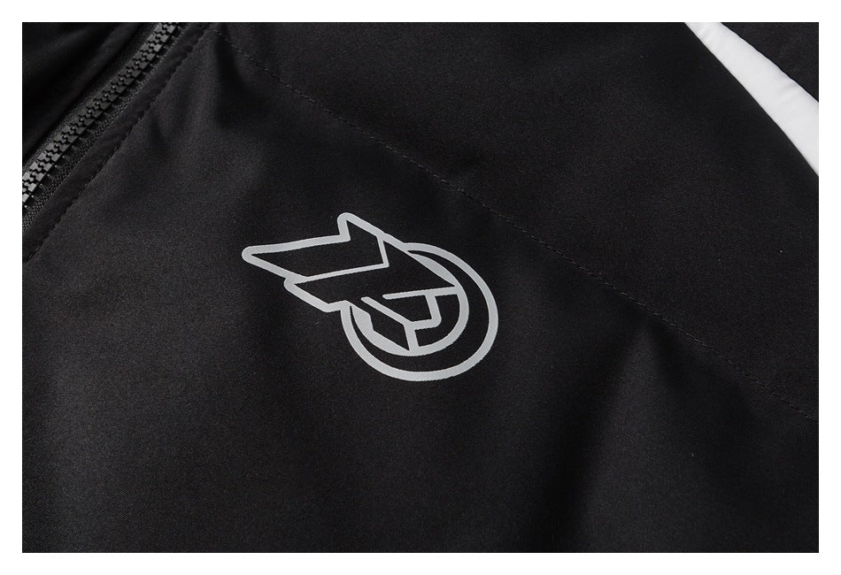 Close-up of a white outlined emblem printed on the black jacket.