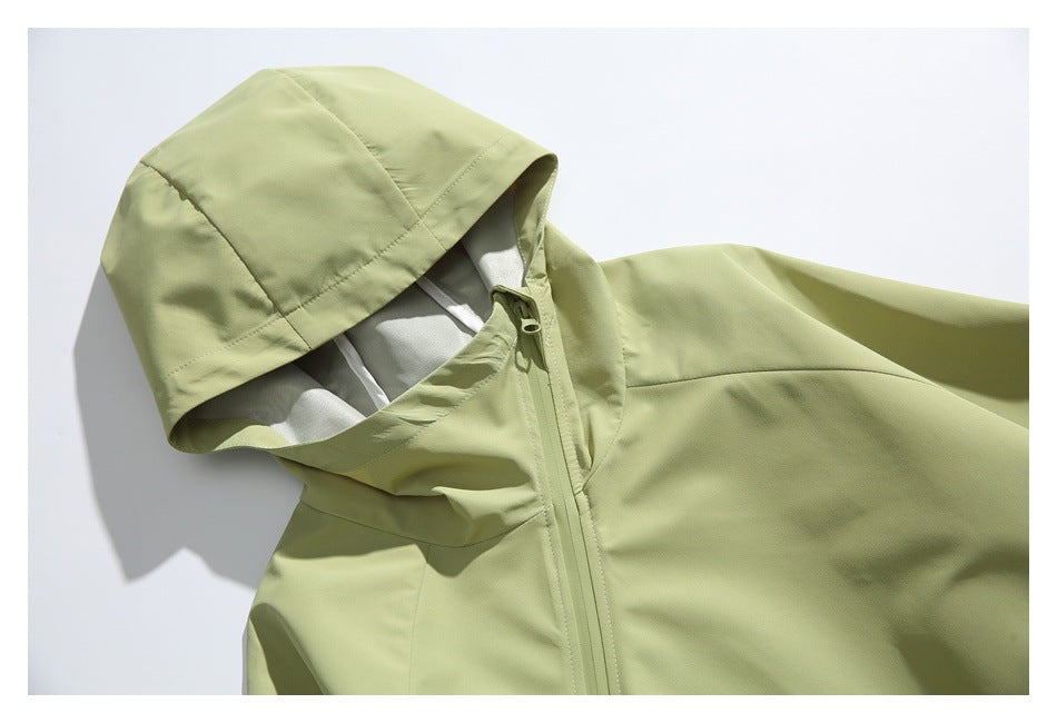 Close-up of the pale yellow-green jacket's hood, collar, and front zipper.