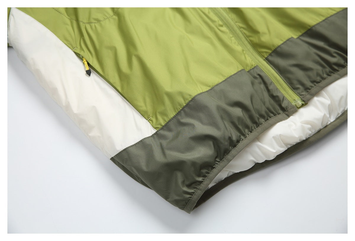Close-up of the jacket's color-blocked lower hem in olive green, charcoal gray, and white.