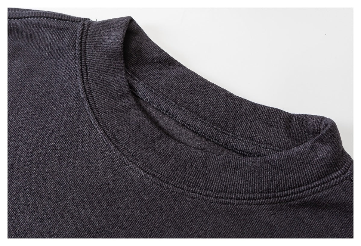 Close-up of a dark charcoal crew neckline with a ribbed collar and visible stitching.