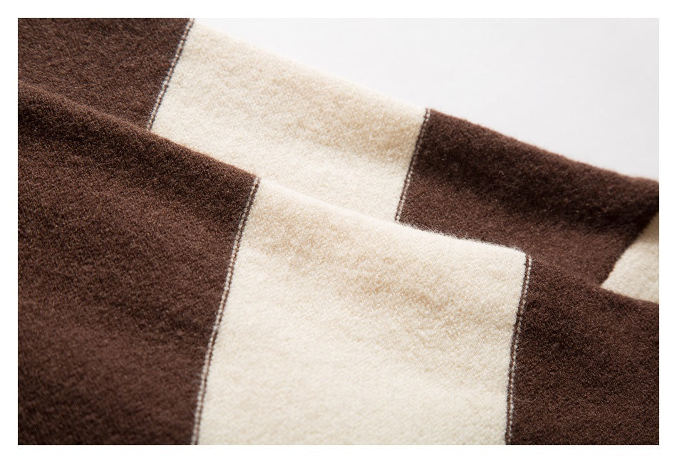 Close-up of broad cream and dark brown knit stripes with visible seam edges.