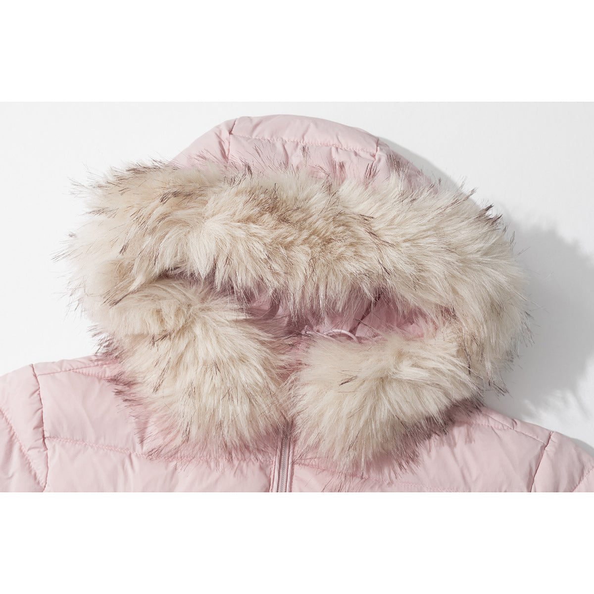 Close-up of a pale pink quilted jacket hood with thick beige faux-fur trim.