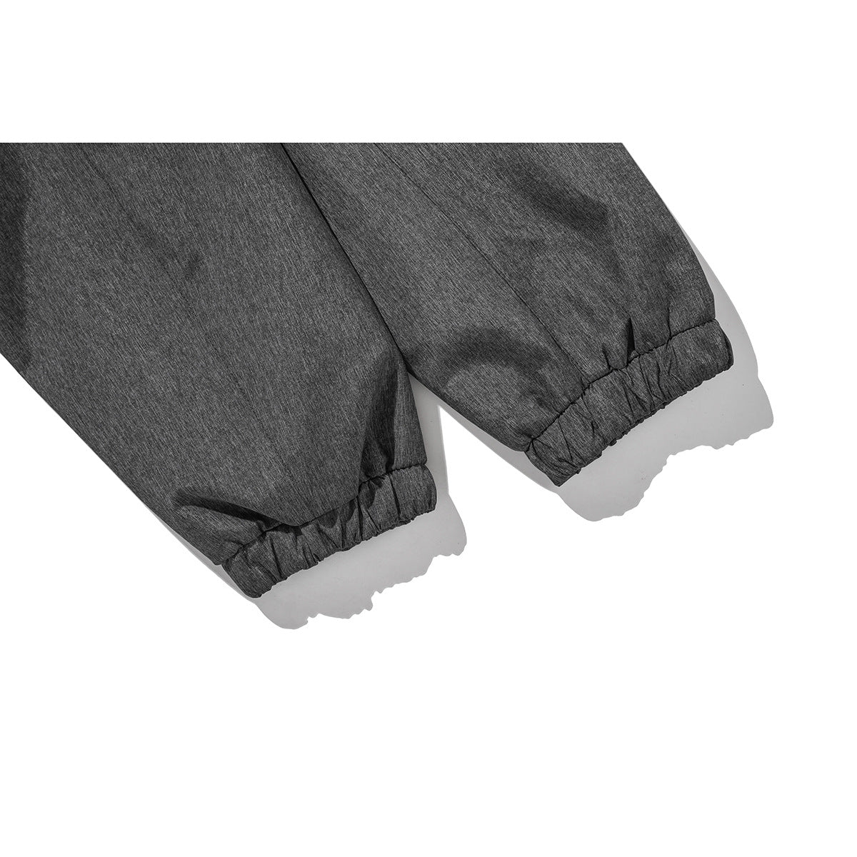 Close-up of dark gray jacket sleeves with gathered elastic cuffs.