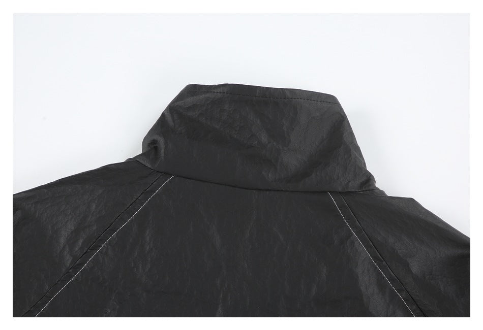 Close-up of the black jacket's raised collar and back shoulder seams.
