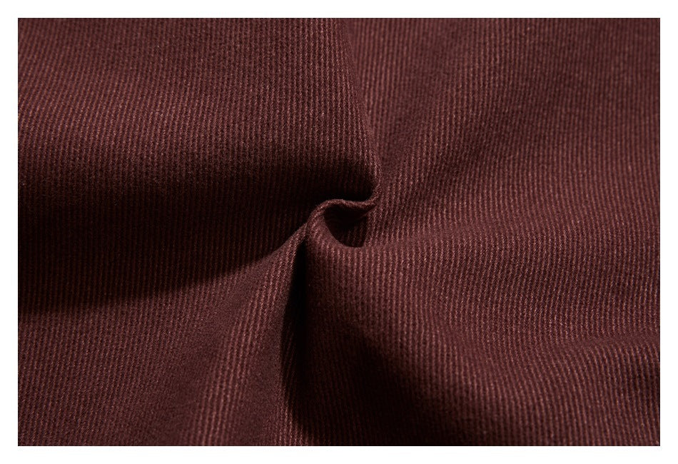 Close-up of burgundy-brown garment fabric showing a fine ribbed texture.