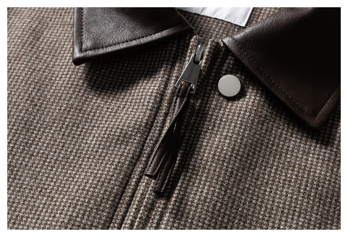 Close-up of the jacket's houndstooth fabric, dark brown collar, metal zipper, and round snap.