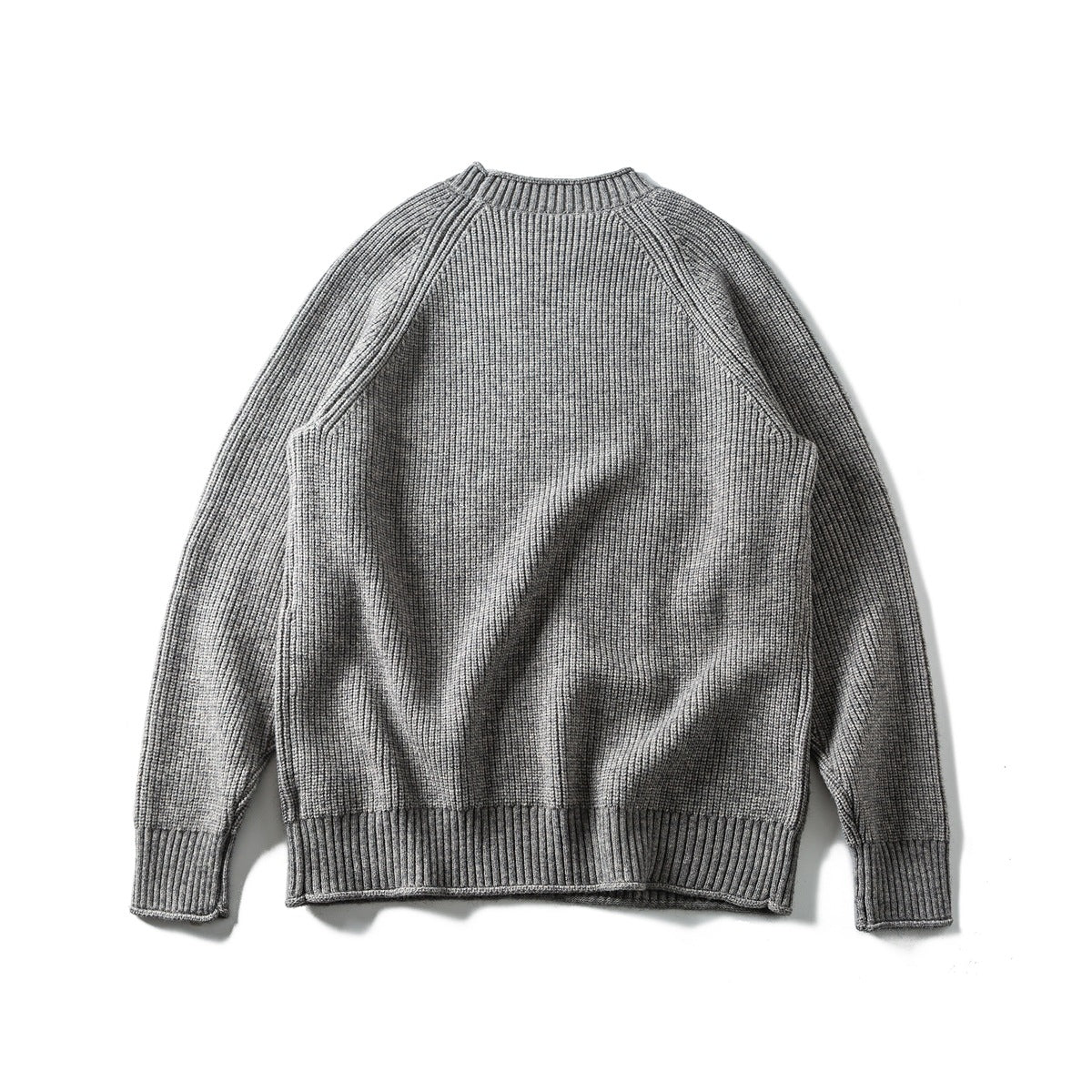 Back view of a gray rib-knit crew-neck sweater with raglan sleeves and ribbed cuffs and hem.