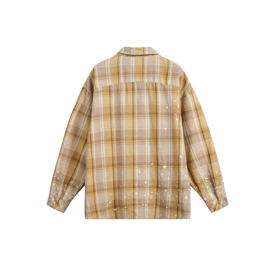 Back of a tan and cream plaid button-up shirt with white paint-splatter accents along the lower half and sleeves.