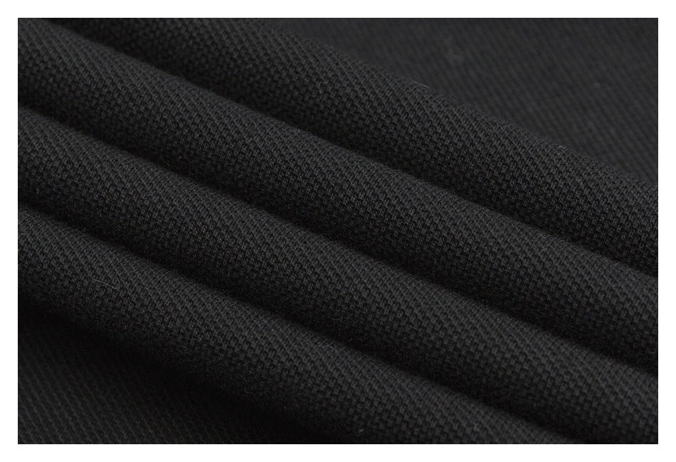 Close-up of black fabric showing a small, textured weave and soft folds.