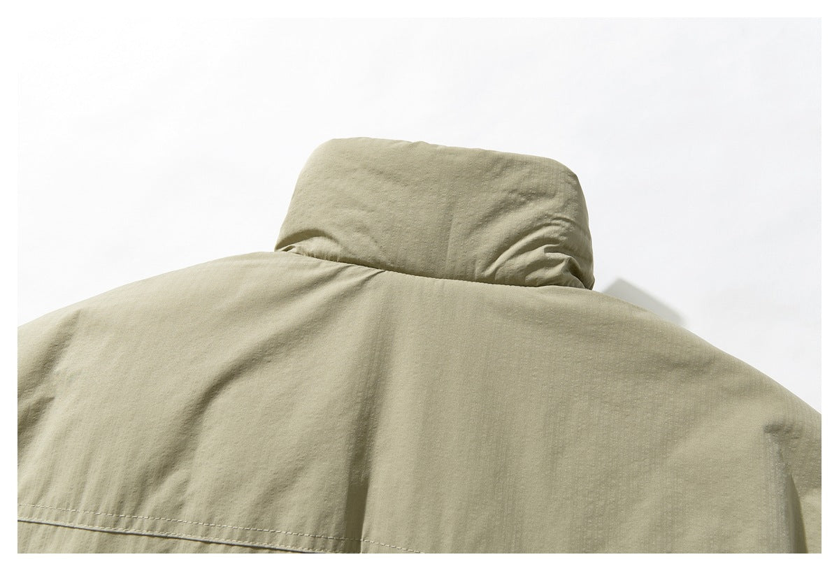Close-up of the khaki jacket's raised collar and stitched upper back panel.