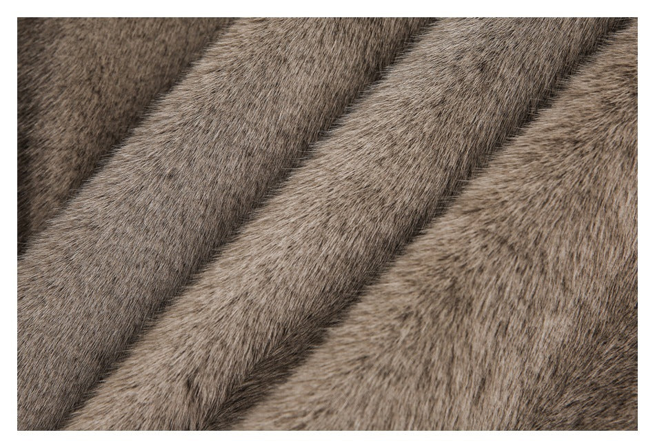 Close-up of taupe-brown plush fur arranged in overlapping diagonal folds.