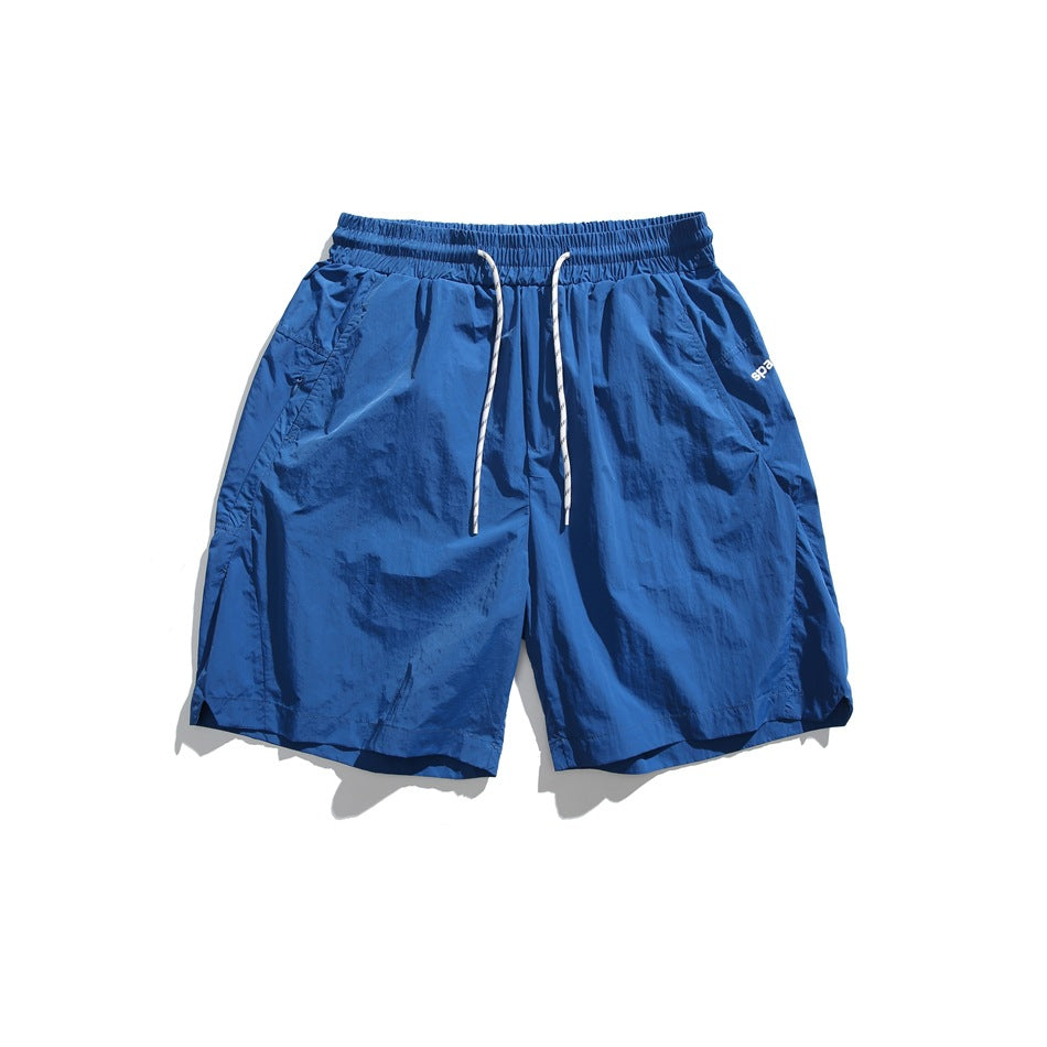 Royal blue drawstring shorts with white cord, flat lay front view