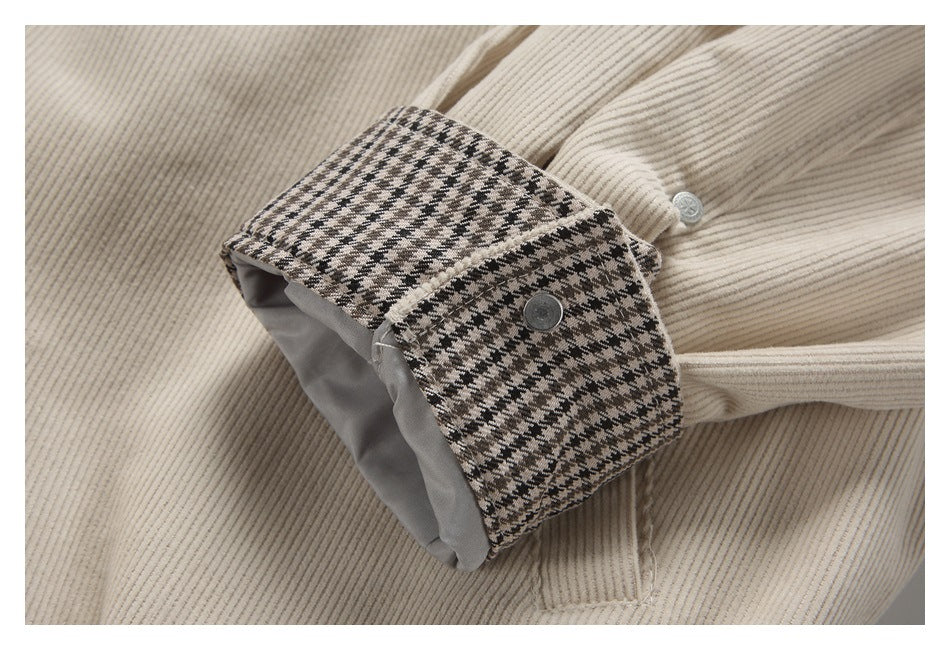 Cream ribbed sleeve with a buttoned cuff tab featuring a black-and-beige houndstooth lining.
