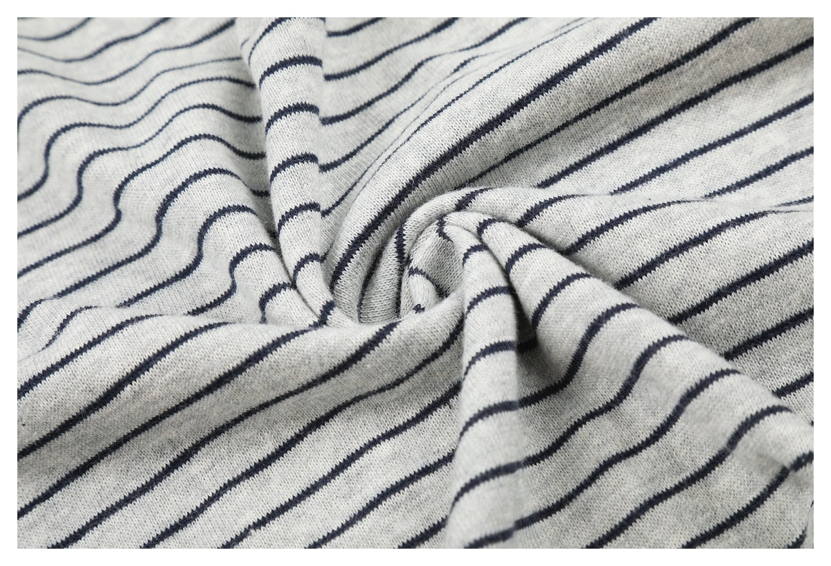 Close-up of light gray knit fabric with thin navy stripes gathered into soft folds.