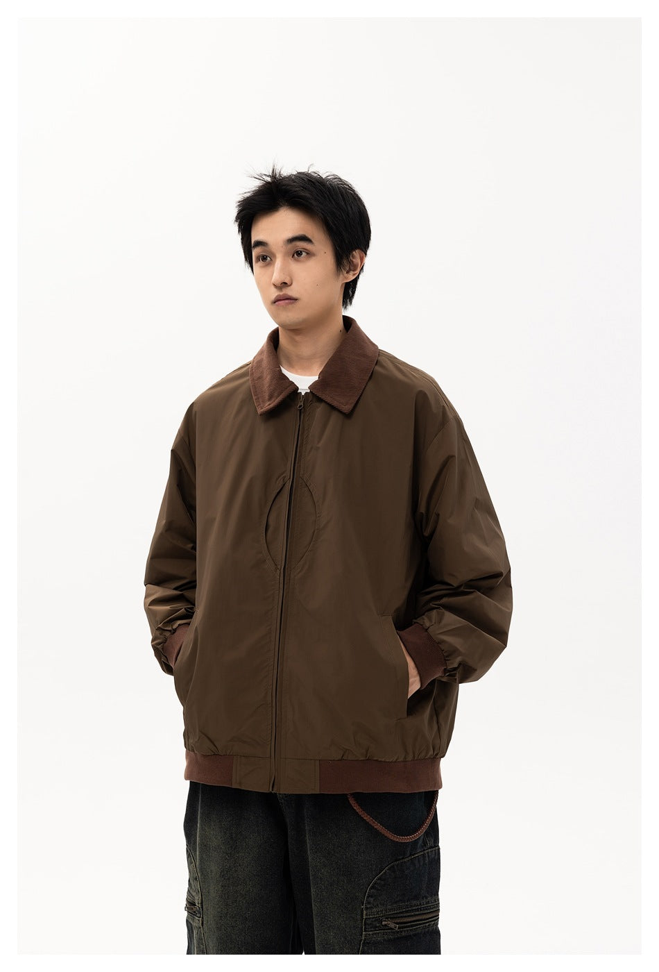 Male model wears a zipped dark brown jacket with a brown corduroy collar, ribbed cuffs and hem.