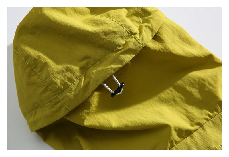 Close-up of the yellow-green jacket hood's drawcord and toggle.