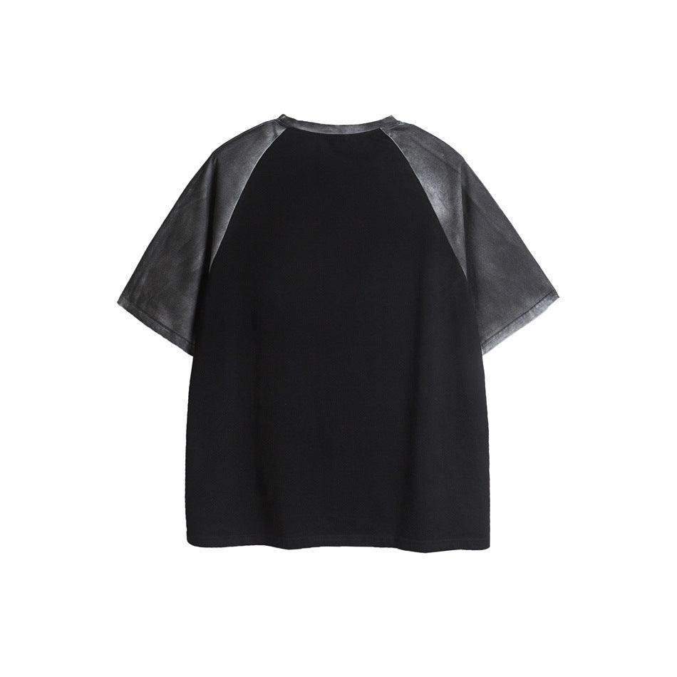 Back view of a black raglan T-shirt with washed charcoal sleeves.