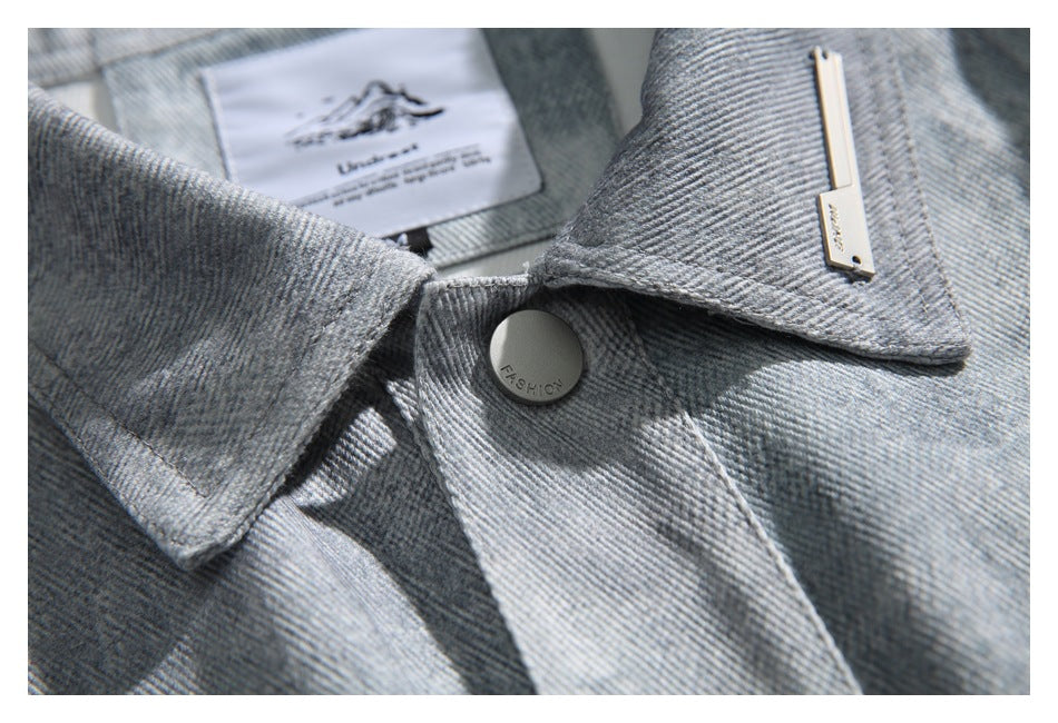 Close-up of the jacket collar and snap button, with a small sewn-in neck label.