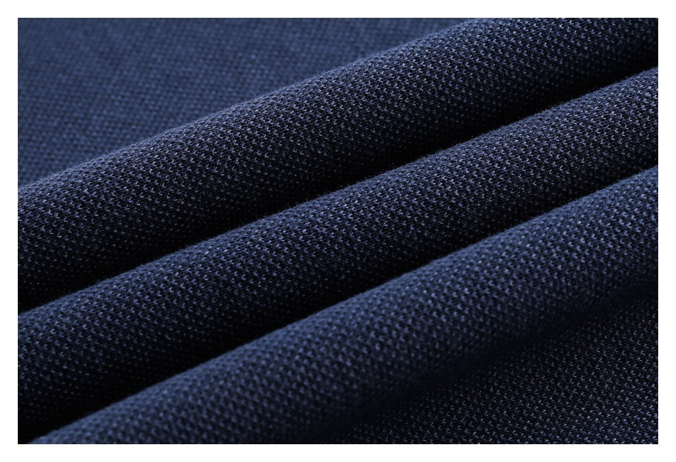 Close-up of dark navy fabric with a fine, textured knit surface.