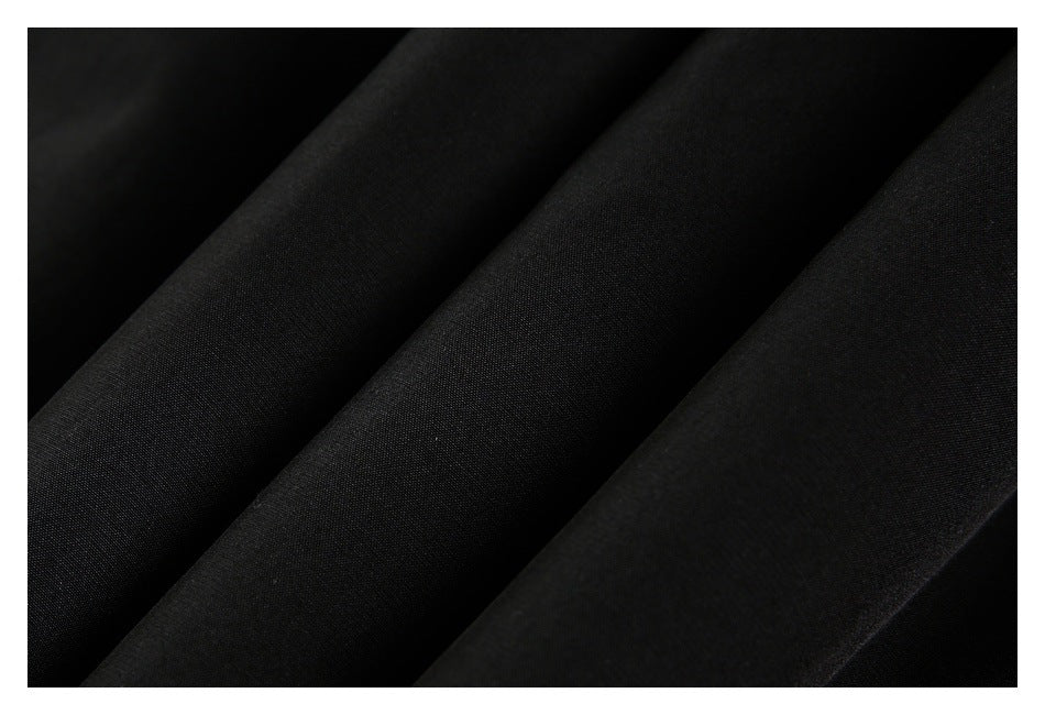 Close-up showing the fine texture and folds of black fabric.