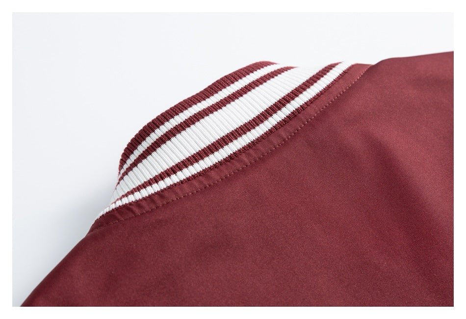 Close-up of the burgundy jacket neckline with a ribbed collar striped in burgundy and white.