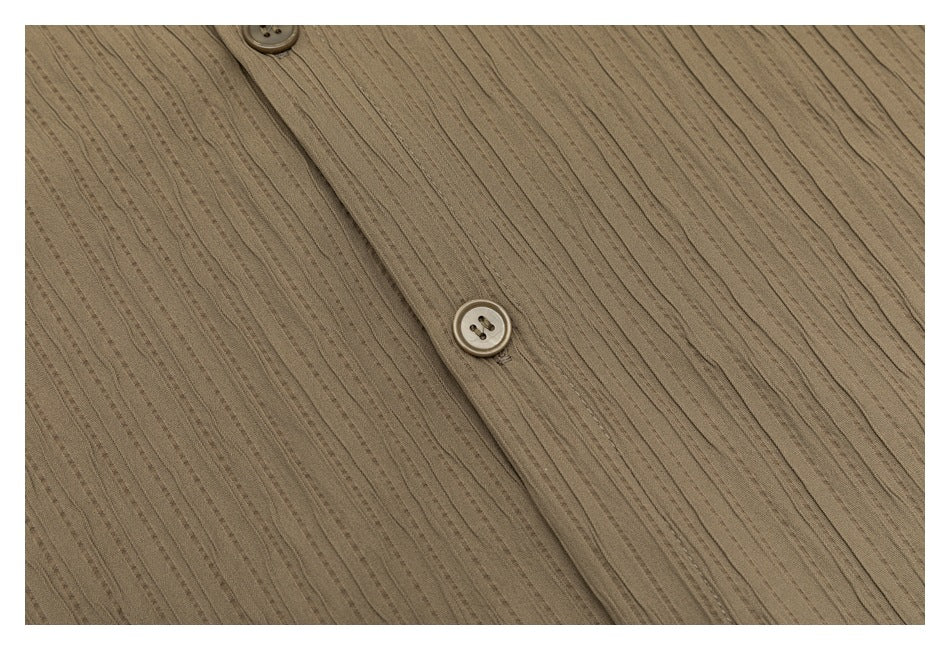 Close-up of the taupe shirt's button placket and narrow vertical textured stripes.