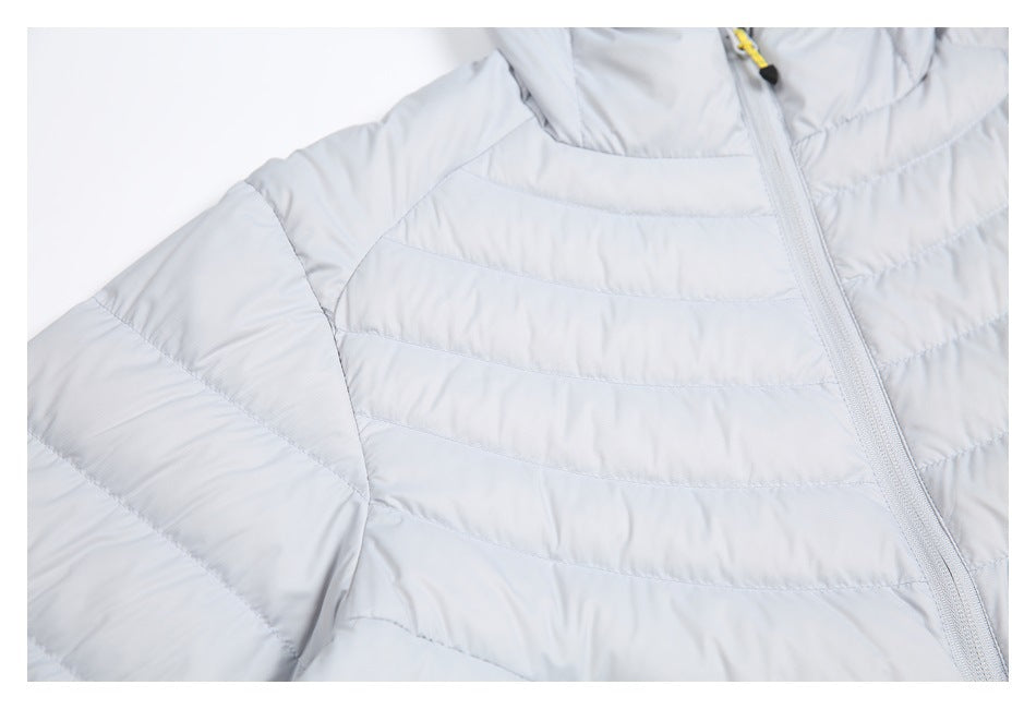 Close-up of the light gray jacket's quilted shoulder and front panel beside its main zipper.