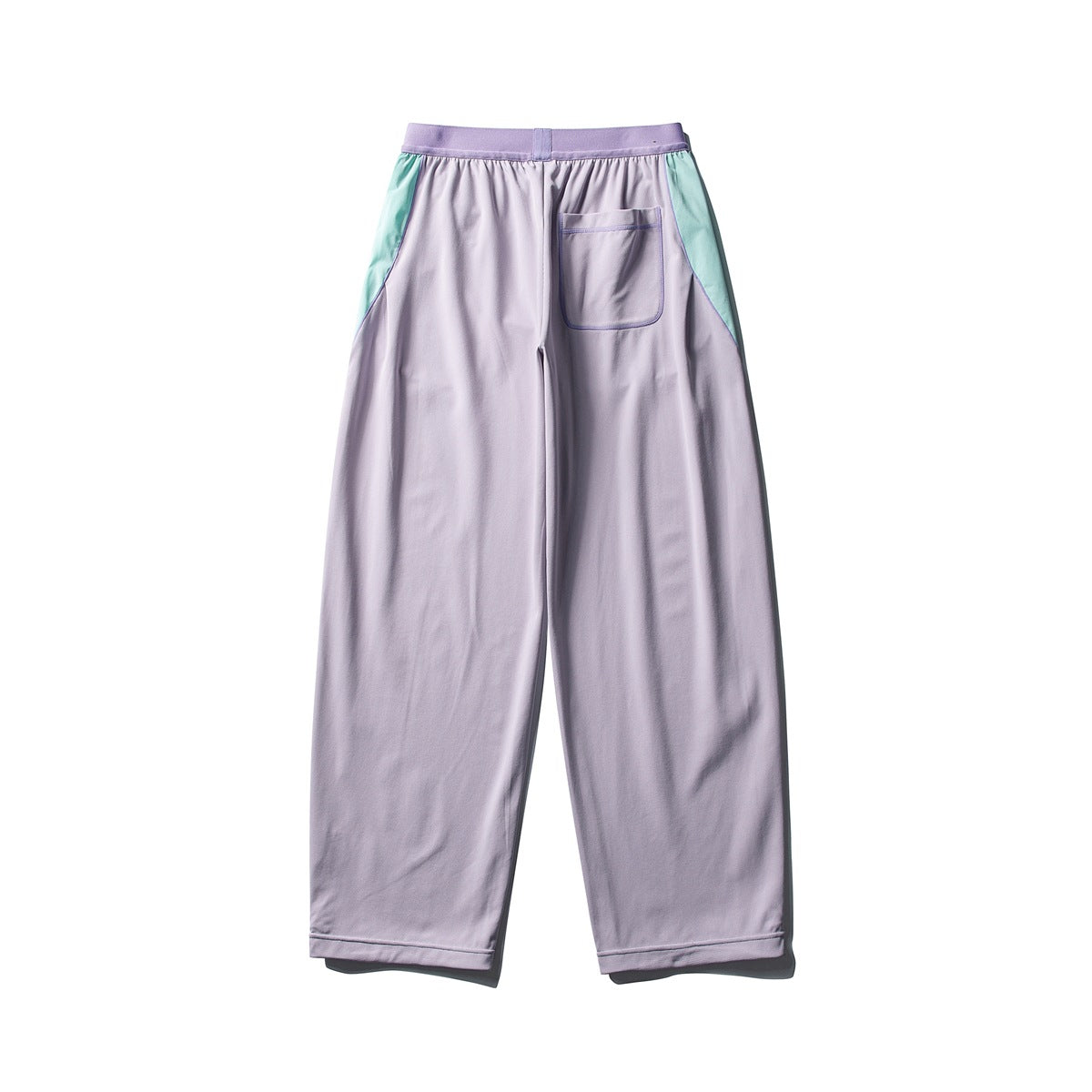 Back view of lavender wide-leg pants with mint green side panels, a ribbed waistband and a patch back pocket