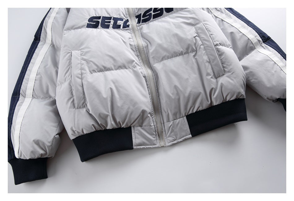 Light gray padded zip jacket laid flat, with navy-and-white sleeve stripes, dark ribbed cuffs and hem, and chest lettering.