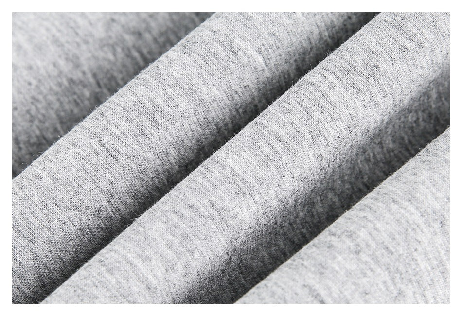 Close-up of heather gray knit fabric folded into soft ridges.